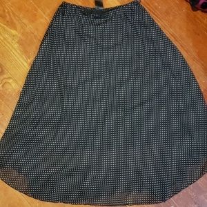 A shaped long black and  polka dot skirt.